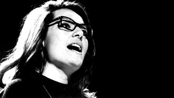 Logo for The Singer Behind the Glasses: The Story Of Nana Mouskouri